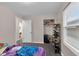 Comfortable bedroom with wood flooring, open door and closet space at 2055 N Somerset Ave, Indianapolis, IN 46222