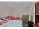 Bedroom with decorative pillows, colorful bedding, and a dresser against neutral walls at 2055 N Somerset Ave, Indianapolis, IN 46222