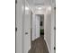 Hallway view showcasing neutral walls and wood flooring, providing access to the various rooms at 2055 N Somerset Ave, Indianapolis, IN 46222