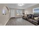 Inviting living room with bright windows, a modern floor, and comfortable seating at 2055 N Somerset Ave, Indianapolis, IN 46222