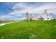 A large grassy lawn and lake offer a serene setting in this home's backyard at 2416 Meadow Bend Dr, Columbus, IN 47201