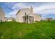 An exterior view of a two-story home showing the yard and screened porch at 2416 Meadow Bend Dr, Columbus, IN 47201