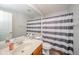 Bathroom featuring a vanity with sink, toilet, mirror, and a shower with a striped curtain at 2416 Meadow Bend Dr, Columbus, IN 47201
