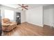 A cozy bedroom featuring a recliner chair, wood-look flooring, and ample natural light at 2416 Meadow Bend Dr, Columbus, IN 47201
