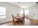 Bright dining room with wood floors, a wooden table with seating for four, and plenty of natural light at 2416 Meadow Bend Dr, Columbus, IN 47201