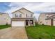 Charming two-story home with a two-car garage and well-maintained lawn and inviting curb appeal at 2416 Meadow Bend Dr, Columbus, IN 47201
