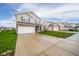 Traditional two-story home featuring a brick accent, a two-car garage, and a driveway at 2416 Meadow Bend Dr, Columbus, IN 47201