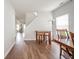 Hallway with wooden floors, a table and stools, and views of the kitchen and staircase at 2416 Meadow Bend Dr, Columbus, IN 47201