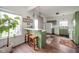 Bright kitchen with green cabinets, white appliances, breakfast bar, and wood-look flooring at 2416 Meadow Bend Dr, Columbus, IN 47201