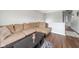 Comfortable living room area featuring a sectional sofa, coffee table, and wood-look flooring at 2416 Meadow Bend Dr, Columbus, IN 47201