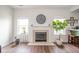 Cozy living room with a fireplace, hardwood floors, and large windows for natural light at 2416 Meadow Bend Dr, Columbus, IN 47201