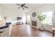 Spacious living room featuring a fireplace, ceiling fan, hardwood floors, and large windows at 2416 Meadow Bend Dr, Columbus, IN 47201