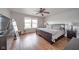 Bright bedroom with a dark wood bed set, ceiling fan, and natural light from the dual windows at 2416 Meadow Bend Dr, Columbus, IN 47201