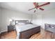 Comfortable bedroom with a dark wood bed set, ceiling fan, and coordinated lamps on nightstands at 2416 Meadow Bend Dr, Columbus, IN 47201