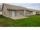 Spacious backyard with lush lawn, patio, and sliding glass doors leading indoors at 2813 W Long Meadow Ln, Muncie, IN 47304