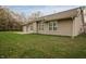 Large backyard featuring green grass, mature trees and a concrete patio area at 2813 W Long Meadow Ln, Muncie, IN 47304