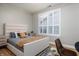 Comfortable bedroom features a cushioned headboard, with coordinating nightstands, and stylish shuttered windows for natural light at 2813 W Long Meadow Ln, Muncie, IN 47304