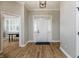 Open foyer featuring hardwood floors, a classic white door, and a view into the adjacent dining area at 2813 W Long Meadow Ln, Muncie, IN 47304