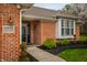 Close-up of a well-maintained home entrance with brick facade, manicured shrubs, and clear address display at 2813 W Long Meadow Ln, Muncie, IN 47304