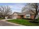Inviting single story brick home with well-maintained landscaping, mature trees, and attached garage at 2813 W Long Meadow Ln, Muncie, IN 47304