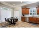 Cozy kitchen boasts stainless steel appliances, warm wood cabinets, and a round dining table with seating for four at 2813 W Long Meadow Ln, Muncie, IN 47304