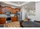 Modern kitchen features stainless steel appliances, warm wood cabinets, and opens to a dining area with a round wood table at 2813 W Long Meadow Ln, Muncie, IN 47304
