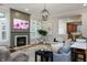 Bright living room featuring a fireplace, ample seating, elegant light fixtures, and access to kitchen at 2813 W Long Meadow Ln, Muncie, IN 47304