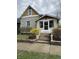 Charming home featuring a welcoming front porch, complemented by blossoming yellow bushes enhancing its curb appeal at 308 N 10Th St, Noblesville, IN 46060