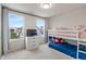 Sunlit bedroom features a bunk bed, dresser, and view of the neighborhood at 3240 Arabian Ln, Zionsville, IN 46077
