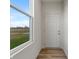 Entryway with hardwood floors, white door and trim and view of open green space at 3240 Arabian Ln, Zionsville, IN 46077