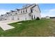New construction townhomes with white siding, two-car garages, and green lawns at 3240 Arabian Ln, Zionsville, IN 46077