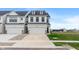 New construction home with white siding, black trim, driveway, and two car garage at 3240 Arabian Ln, Zionsville, IN 46077