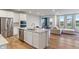 Modern kitchen with stainless steel appliances, granite countertops, and hardwood floors at 3240 Arabian Ln, Zionsville, IN 46077