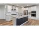 Modern kitchen island with stainless appliances, granite countertops, and stylish backsplash at 3240 Arabian Ln, Zionsville, IN 46077