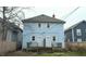 Rear exterior view of a two-story home with light blue siding and a small deck at 3319 N Capitol Ave, Indianapolis, IN 46208