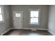 Spacious living room with hardwood floors, large windows, and a white door at 3319 N Capitol Ave, Indianapolis, IN 46208