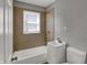 Compact bathroom with vanity, toilet, tub, shower and a window for natural light at 3343 N Drexel Ave, Indianapolis, IN 46218