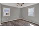 Bedroom featuring neutral walls, two windows providing light, and wood-look flooring at 3343 N Drexel Ave, Indianapolis, IN 46218