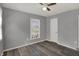 Bedroom featuring neutral walls, a window and a white door, and wood-look flooring at 3343 N Drexel Ave, Indianapolis, IN 46218