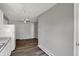 Open-concept kitchen with wood-look flooring, white appliances, and view to adjacent living area at 3343 N Drexel Ave, Indianapolis, IN 46218