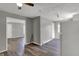 Open layout with grey walls, laminated wood flooring and a refrigerator at the edge of the kitchen at 3343 N Drexel Ave, Indianapolis, IN 46218