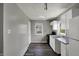 Clean kitchen showcasing white cabinets, modern appliances, and laminate wood flooring at 3343 N Drexel Ave, Indianapolis, IN 46218