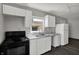 A kitchen featuring white cabinets, a black stove, and stainless steel sink, with a window view at 3343 N Drexel Ave, Indianapolis, IN 46218