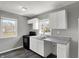 Bright kitchen with white cabinets, black stove, a double sink, and natural light from a window at 3343 N Drexel Ave, Indianapolis, IN 46218