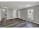 The living room shows hardwood floors, freshly painted gray walls, and multiple entryways at 3343 N Drexel Ave, Indianapolis, IN 46218