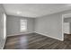 The living room showcases wood flooring, neutral gray walls, and abundant natural light at 3343 N Drexel Ave, Indianapolis, IN 46218