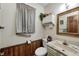 Bathroom showcases a vanity with a marble countertop, wall decor, and wood paneling at 3360 E Main St, Danville, IN 46122