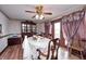 Dining room is lit by a ceiling fan and has a wooden table, chairs, and a decorative hutch at 3360 E Main St, Danville, IN 46122