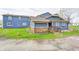 Exterior of a blue home featuring green grass, and a brick foundation at 3360 E Main St, Danville, IN 46122