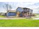 Exterior of a blue two-story house, green grass, with a deck and stairs at 3360 E Main St, Danville, IN 46122